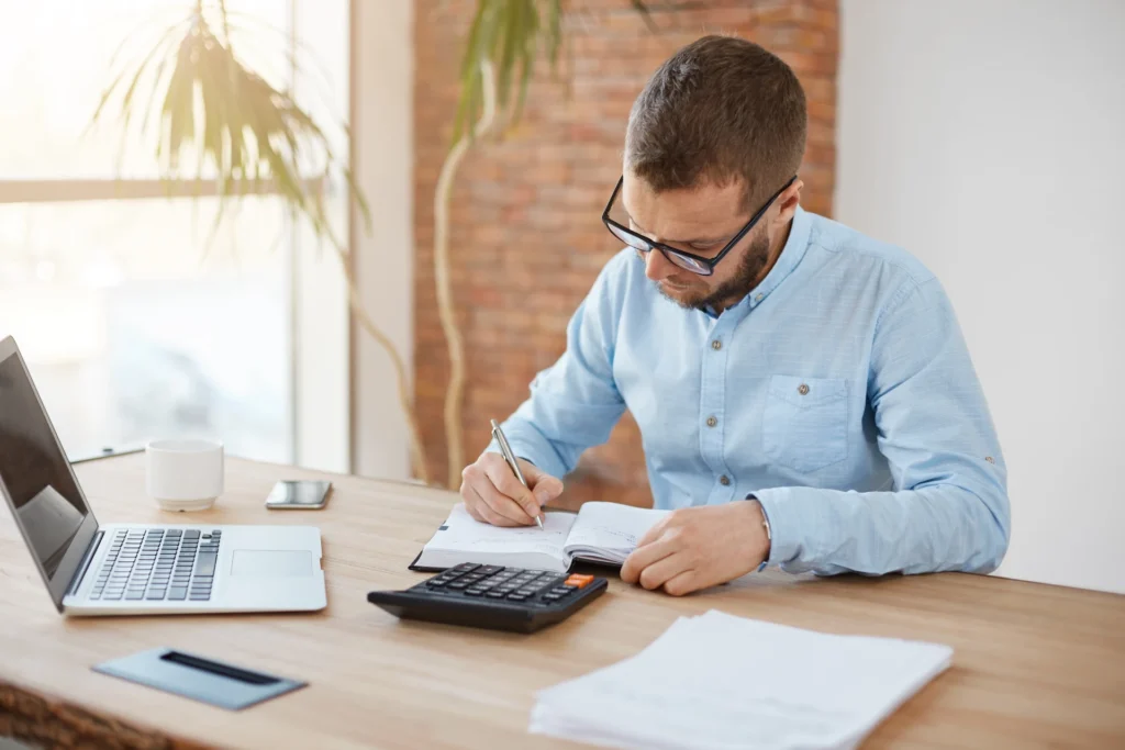 young-caucasian-male-accountant-glasses-sitting-company-office
