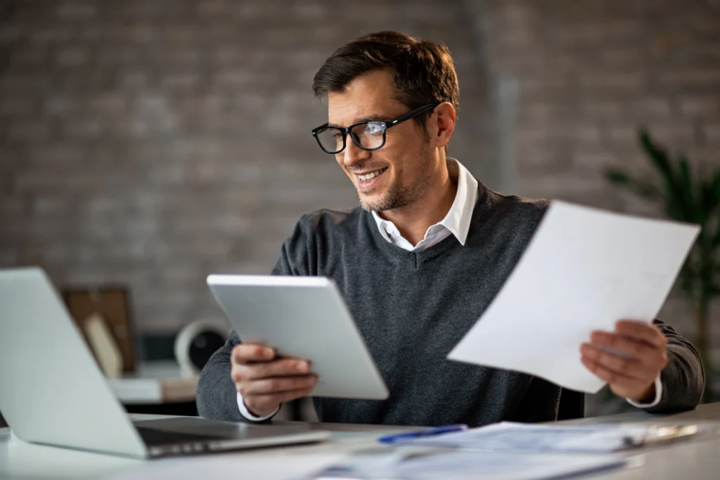 happy-accountant-using-touchpad-laptop-while-working-business-reports-office